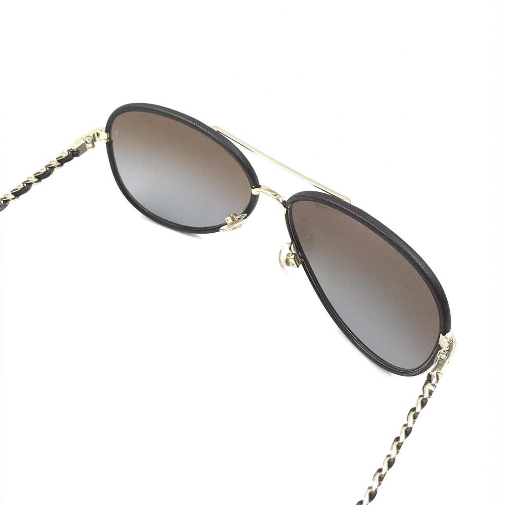 Pre-loved Chanel gold and black polarized aviator sunglasses with protective case