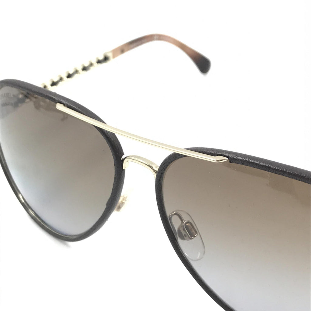 Pre-loved Chanel gold and black polarized aviator sunglasses with protective case