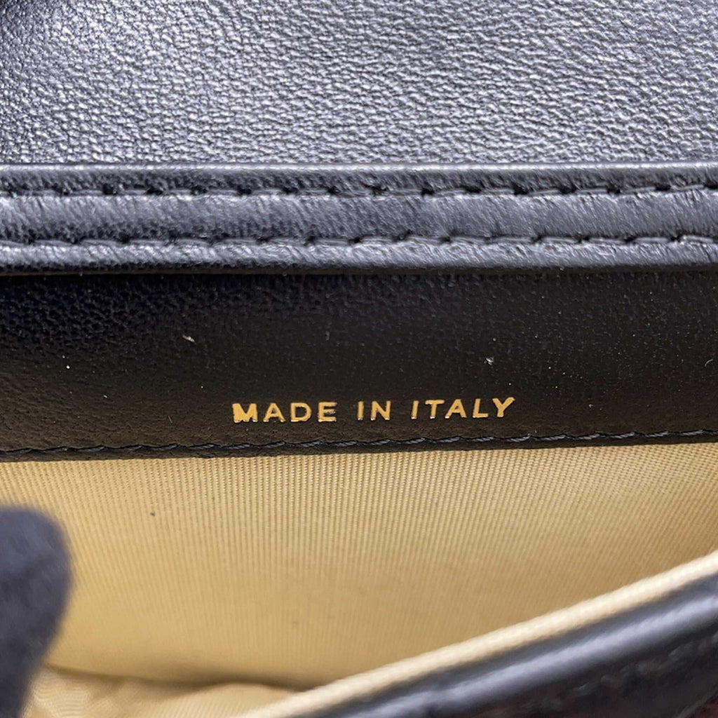 Close-up of the interior label of a Chanel used Ball Bag indicating it is made in Italy