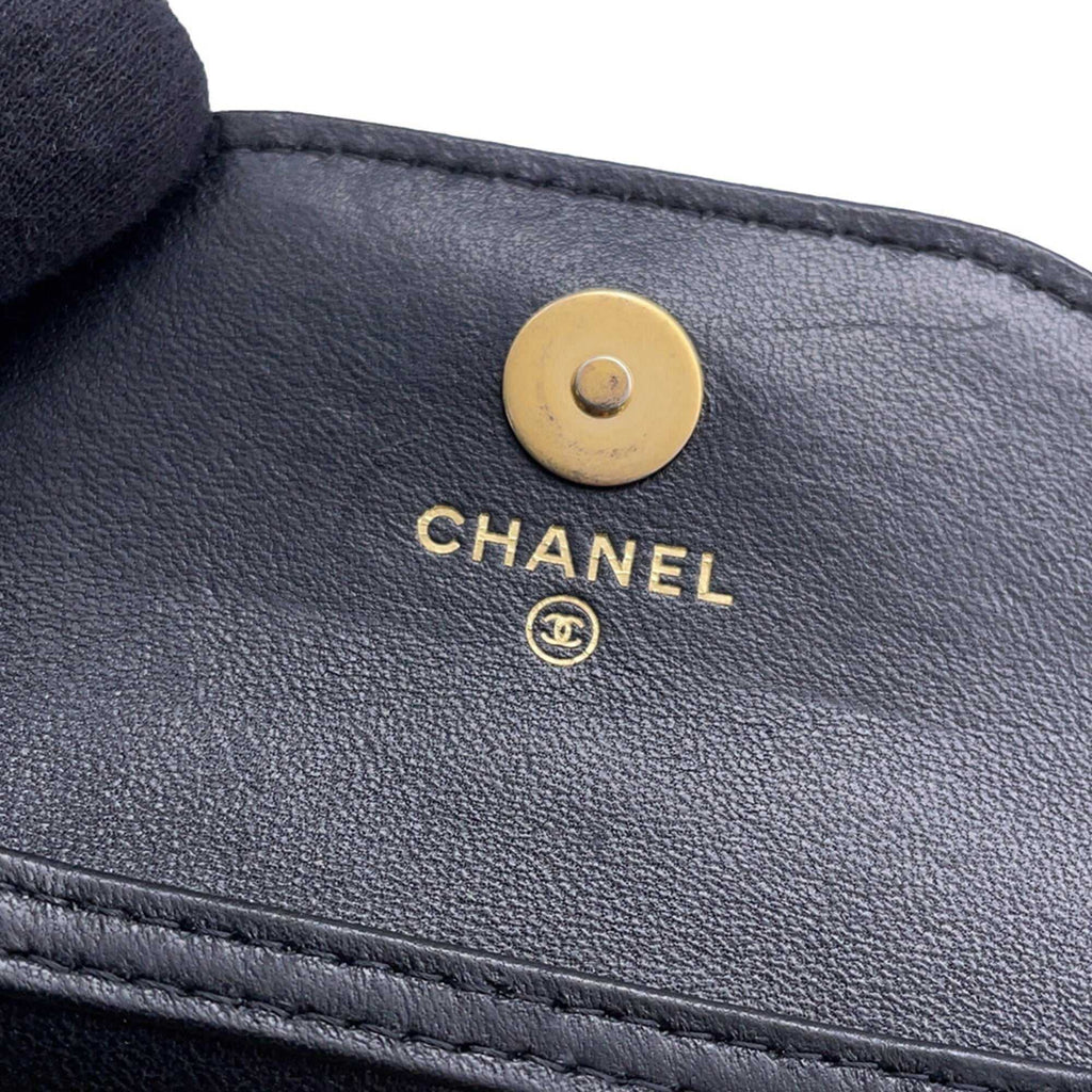 Close-up of the Chanel used Ball Bag logo showcasing its elegant gold hardware and leather texture