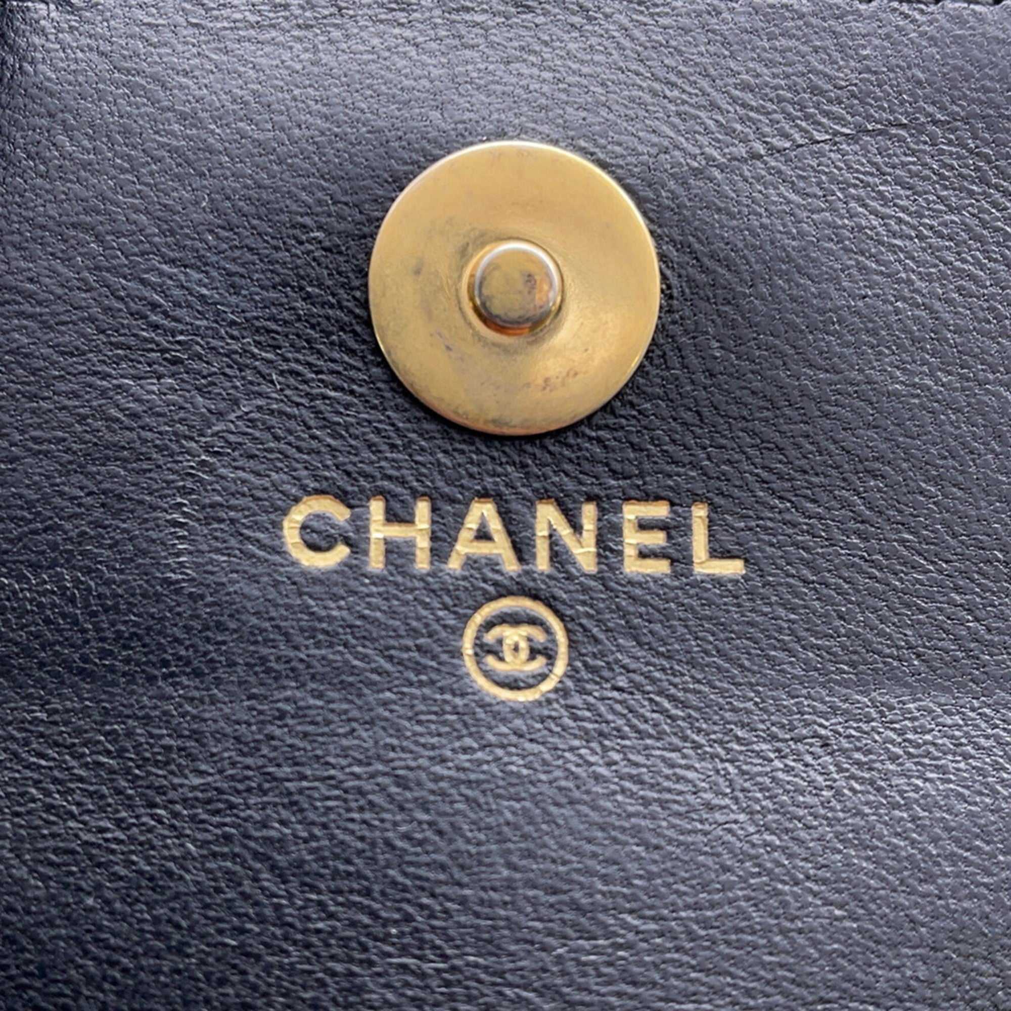 Close-up of a Chanel used Ball Bag with gold logo and snap closure detail