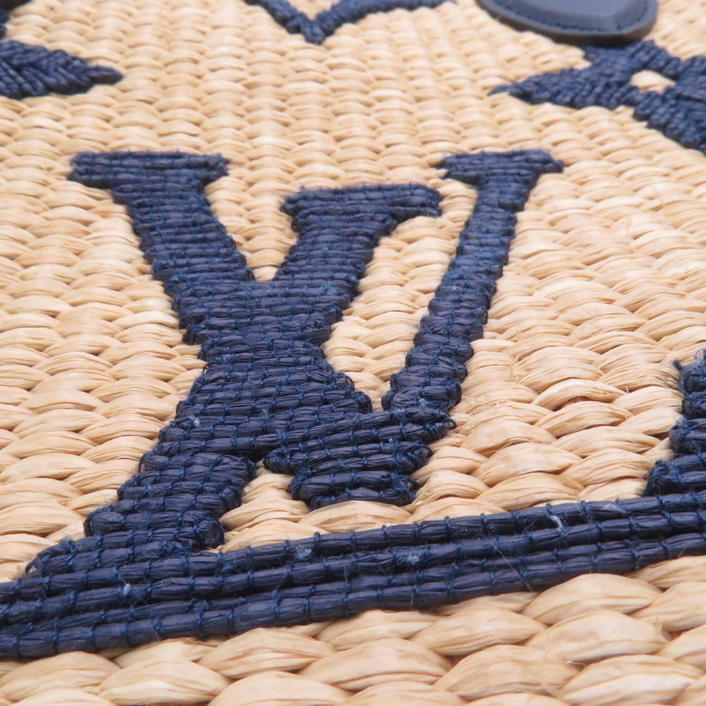 Close-up of LOUIS VUITTON Pre-Loved Monogram Raffia On-the-Go tote bag showing detailed logo design