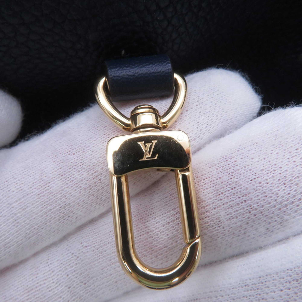 Close-up of gold clasp on LOUIS VUITTON Pre-Loved Monogram Raffia On-the-Go tote bag showcasing quality craftsmanship
