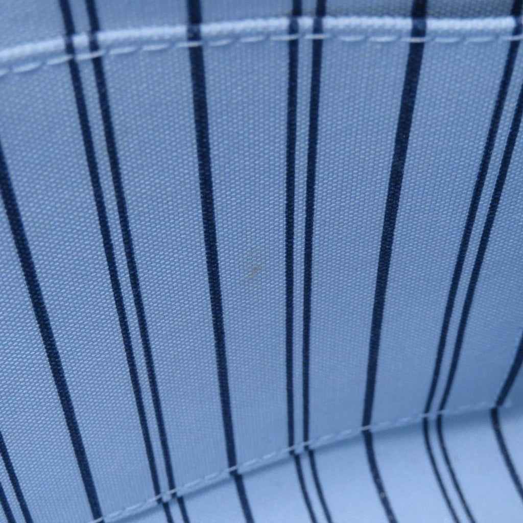 Interior view of LOUIS VUITTON Pre-Loved Monogram Raffia On-the-Go tote bag with blue striped lining