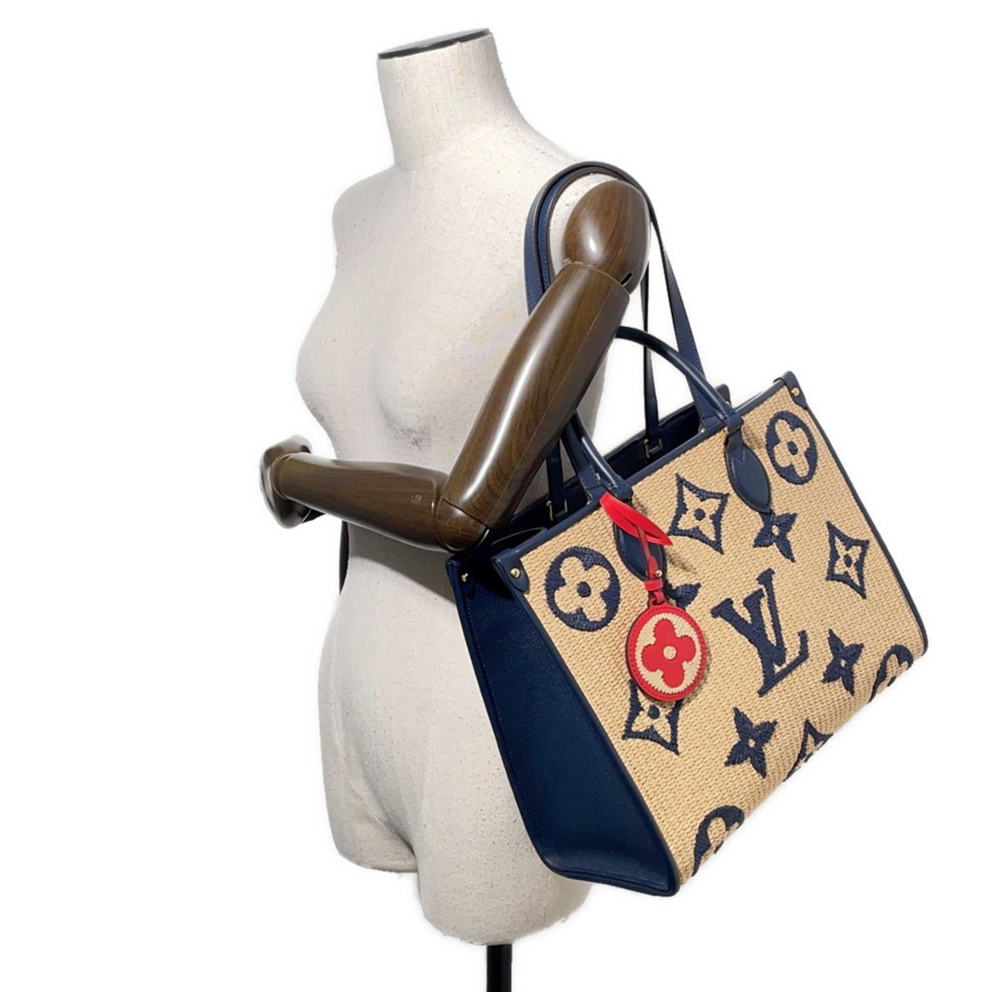 MANSII LOUIS VUITTON Pre-Loved Monogram Raffia On-the-Go tote bag displayed on a mannequin with a stylish design