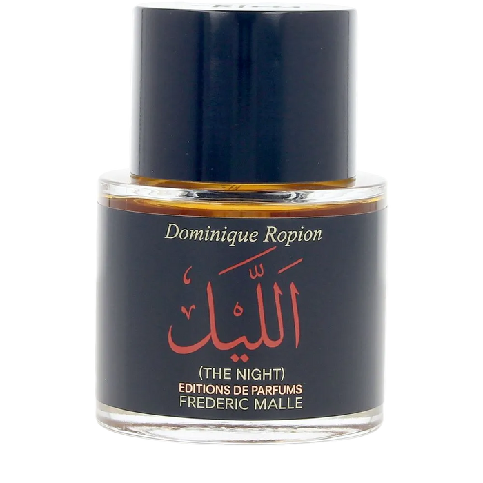 Perfume bottle labeled 'The Night' by Frederic Malle on a white background