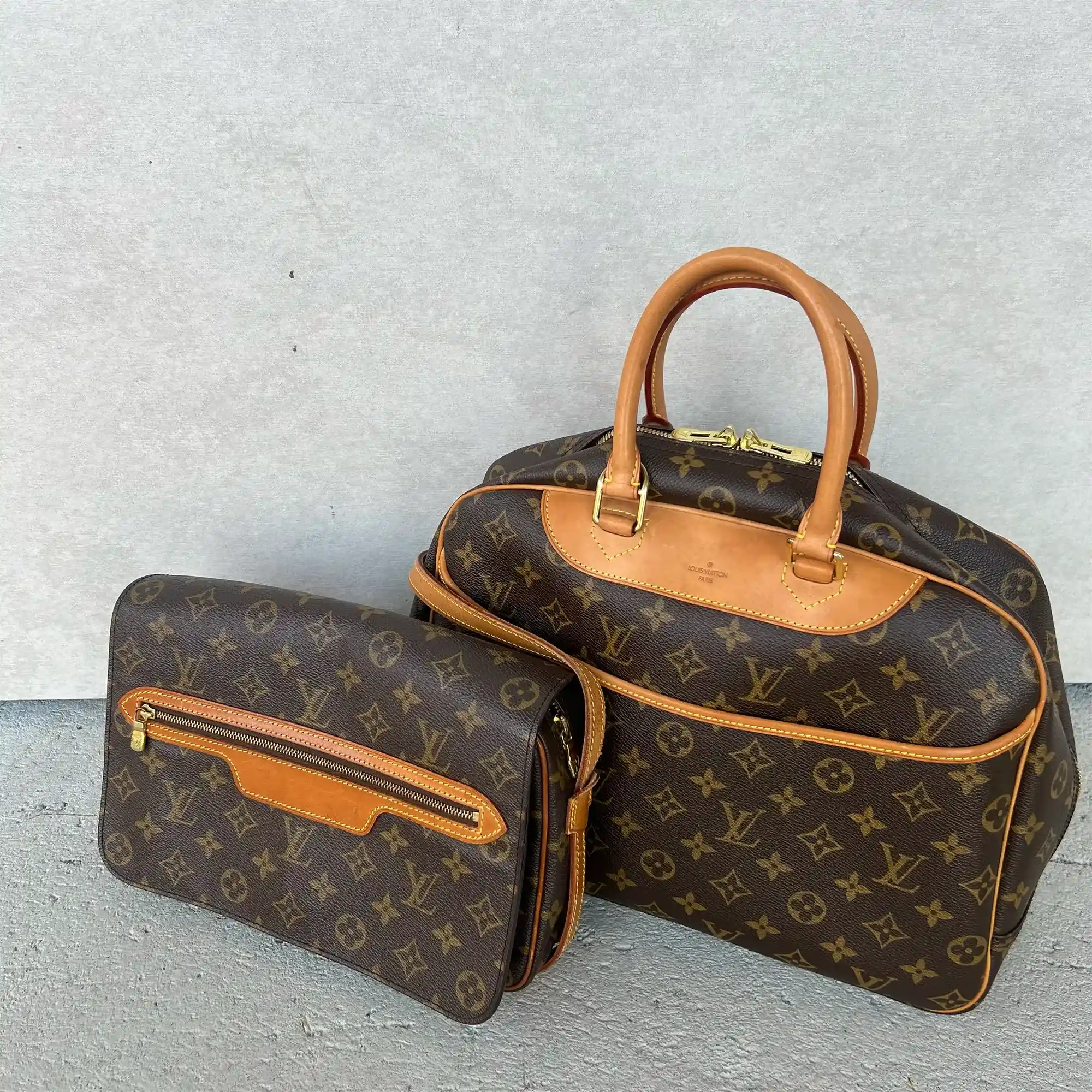 Louis Vuitton monogram Deauville handbag and Saint Geirman Bag on a gray background