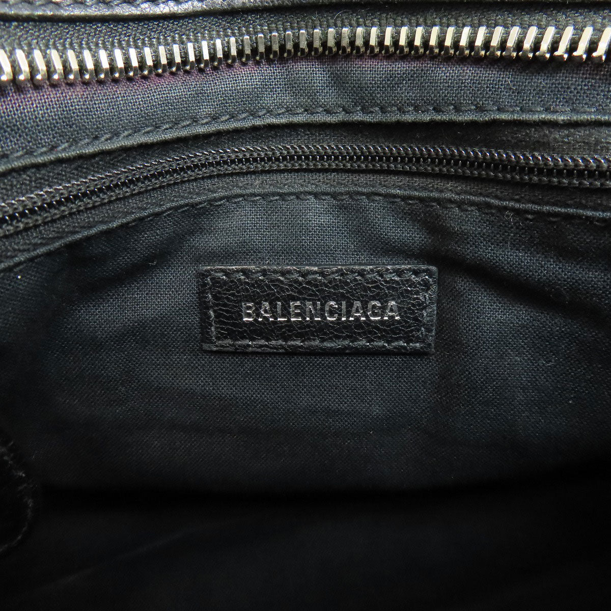 Interior of BALENCIAGA vintage bag showing the logo tag and zipper details