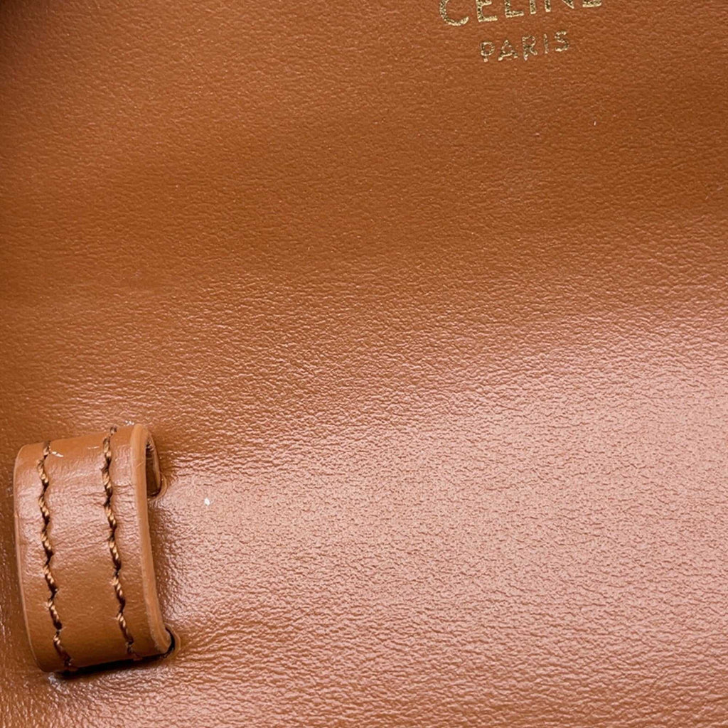 CÉLINE Pre-Loved Mini Claude crossbody bag interior featuring the iconic CÉLINE logo in elegant gold lettering