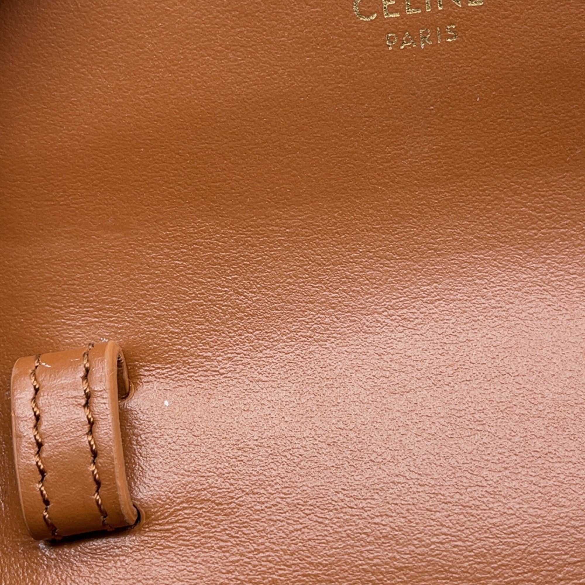 CÉLINE Pre-Loved Mini Claude crossbody bag interior featuring the iconic CÉLINE logo in elegant gold lettering