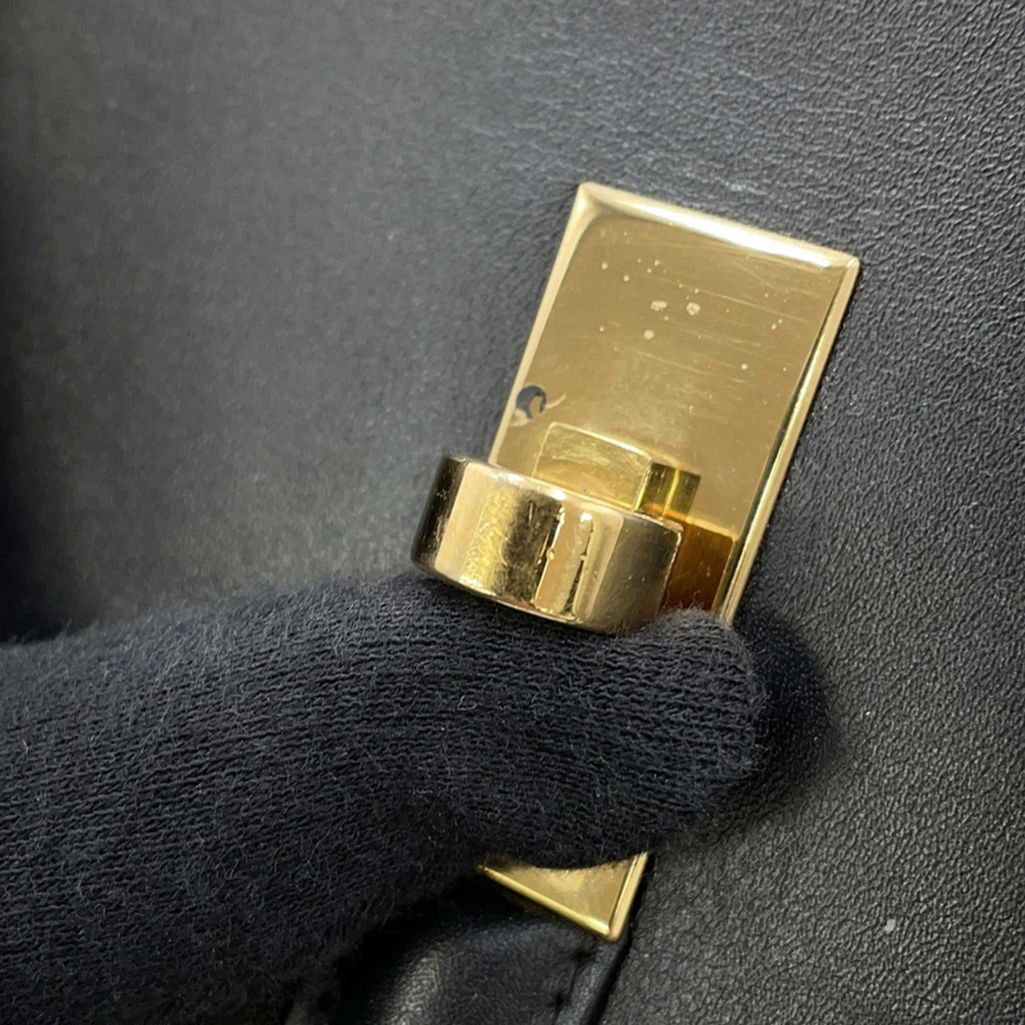 CÉLINE Pre owned 16 Seize handbag detail showing gold clasp and black leather texture