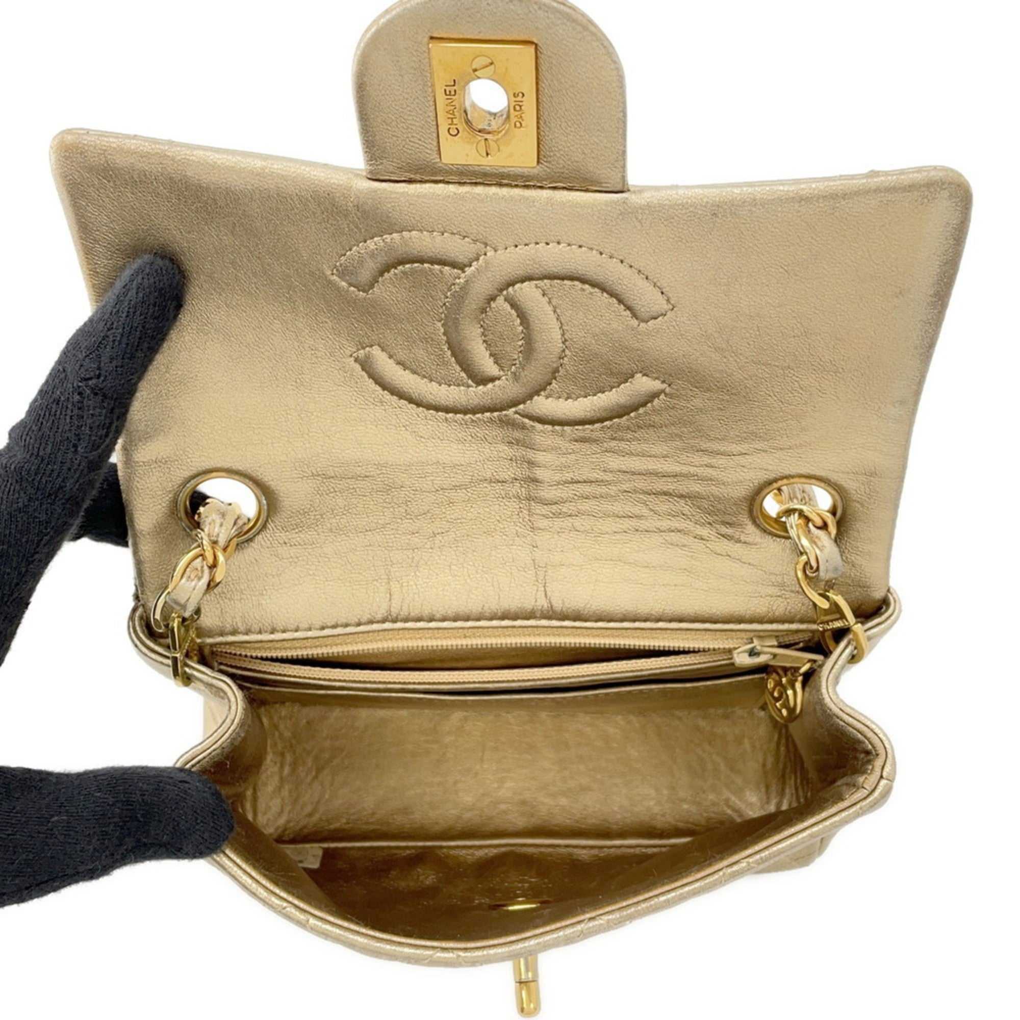 Interior view of authentic Chanel Matelasse 18 for sale in gold leather with iconic logo and spacious compartments