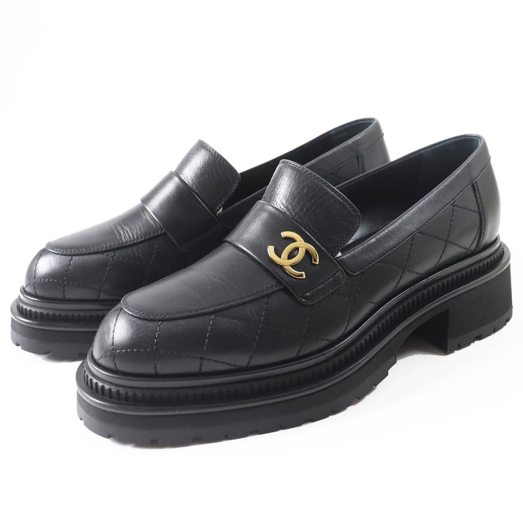 Used Chanel loafers women in black leather with quilted design and signature logo on the strap