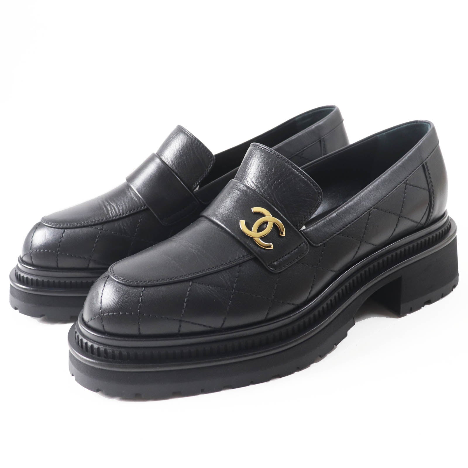 Used Chanel loafers women in black leather with quilted design and signature logo on the strap