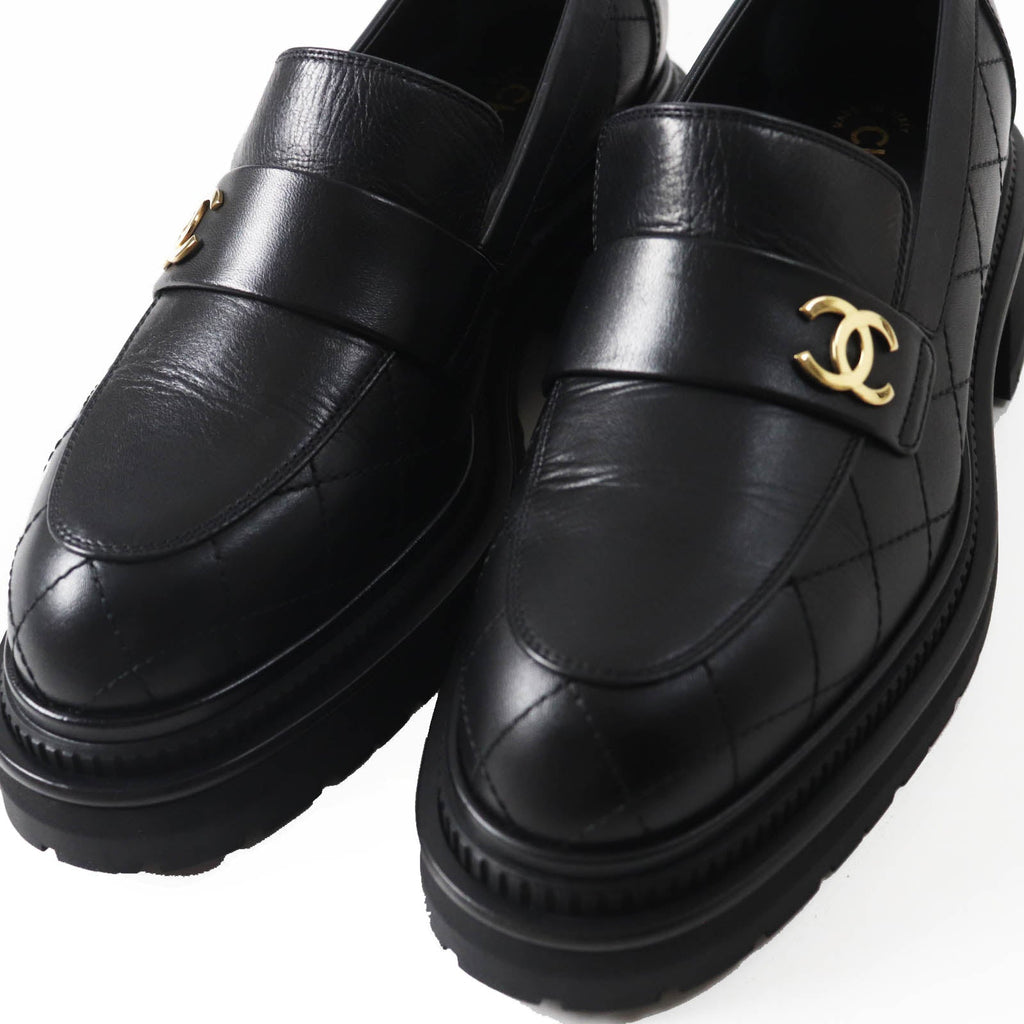 Used Chanel loafers women in black leather with quilted design and gold logo detail