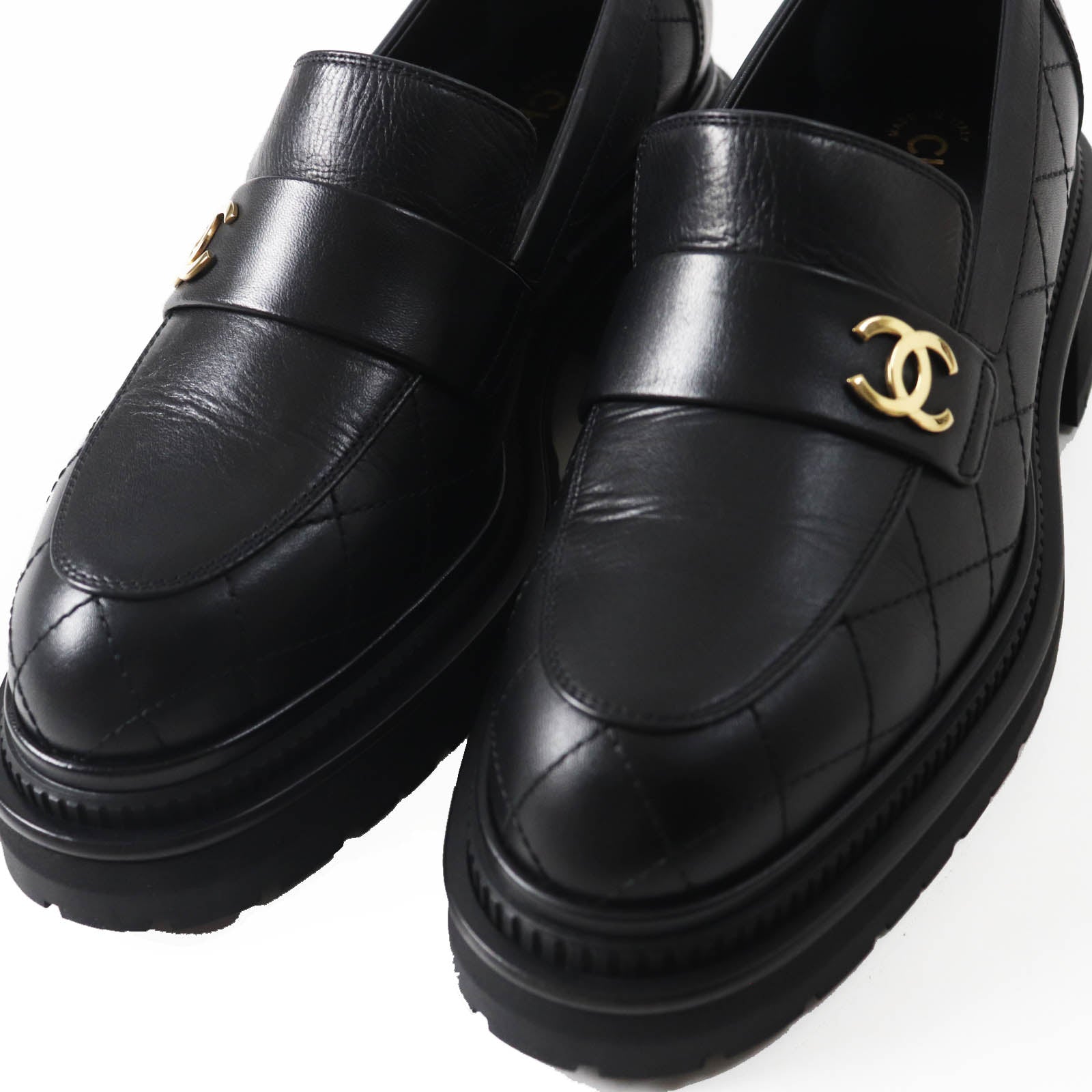 Used Chanel loafers women in black leather with quilted design and gold logo detail