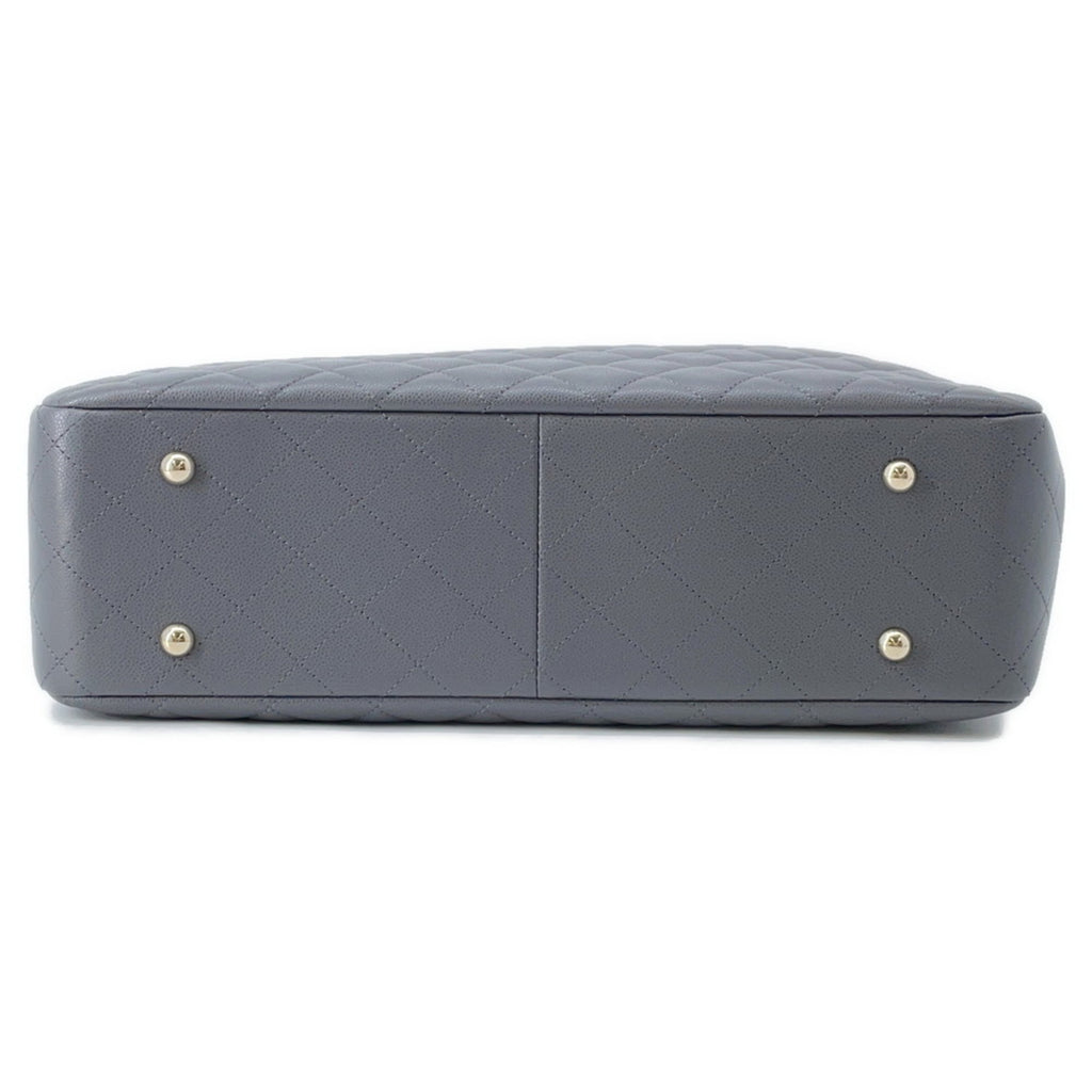 Bottom view of a luxury designer tote bag Chanel with quilted detail and protective metal feet