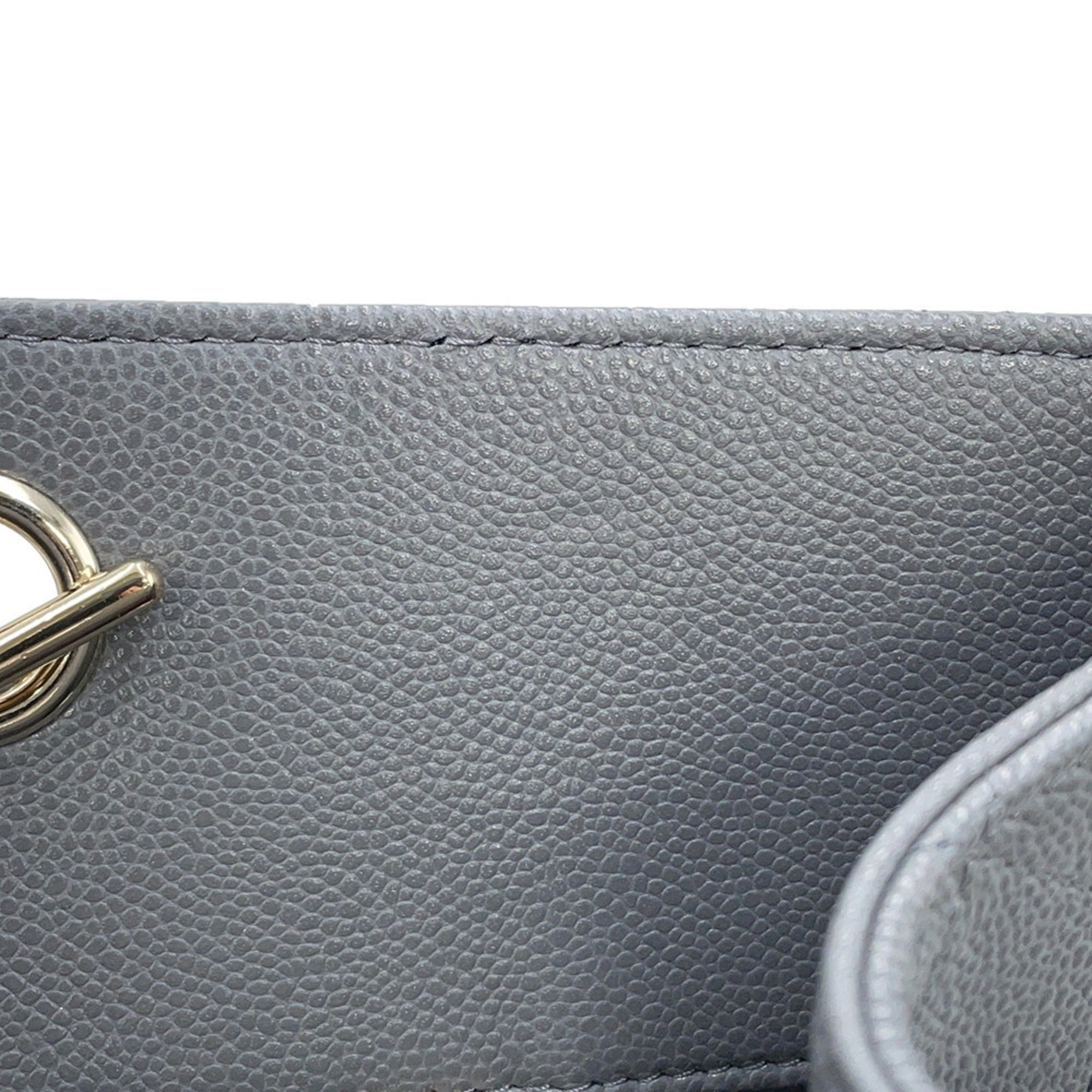 Interior view of a luxury designer tote bag Chanel featuring a sleek gray finish and gold hardware