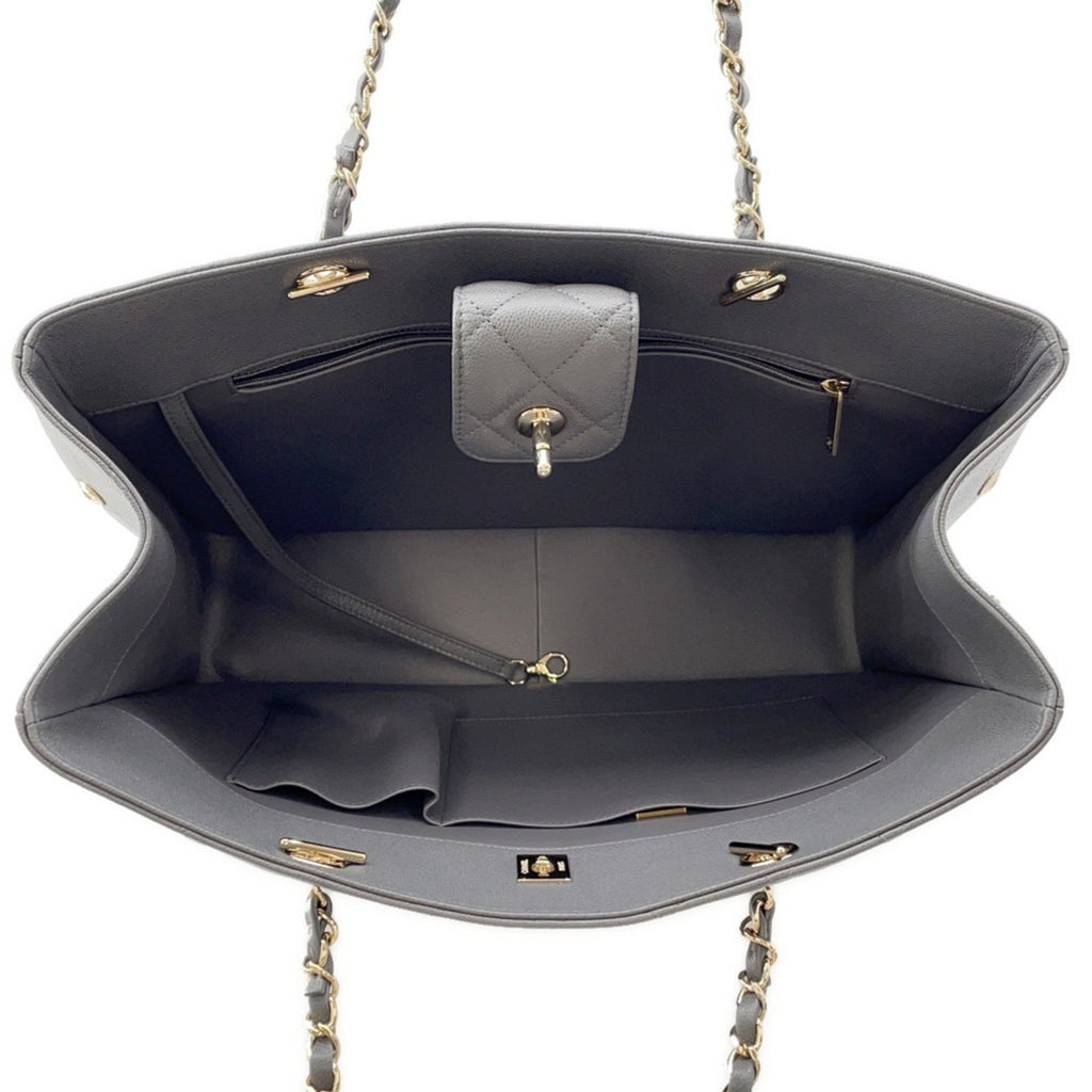 Interior view of luxury designer tote bag Chanel featuring spacious compartments and quilted lining