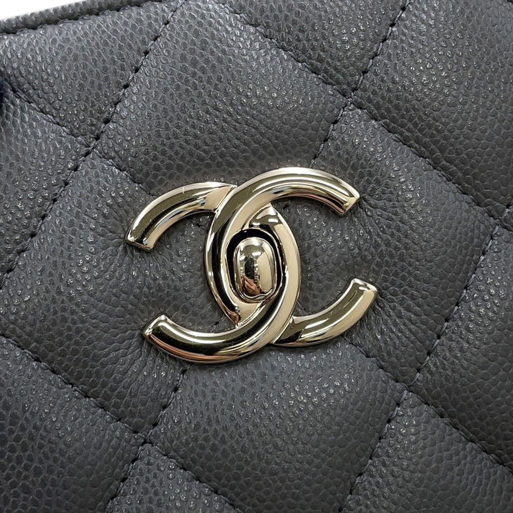 Close-up of luxury designer tote bag Chanel featuring iconic CC logo on textured leather