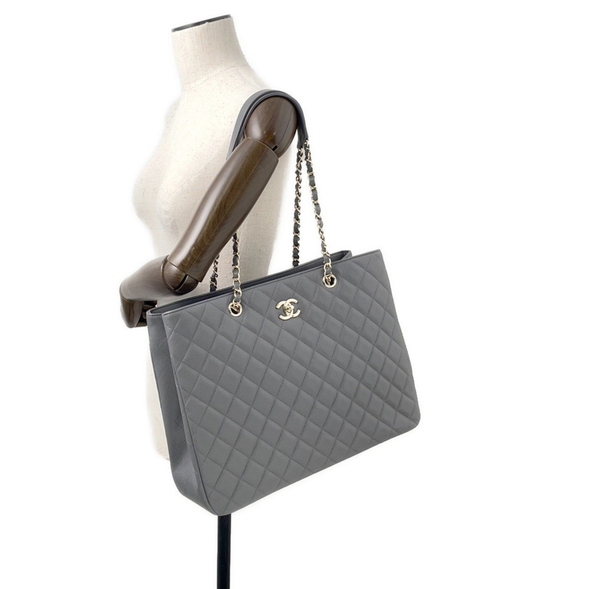 Luxury designer tote bag Chanel in grey quilted leather with chain straps for stylish daily use