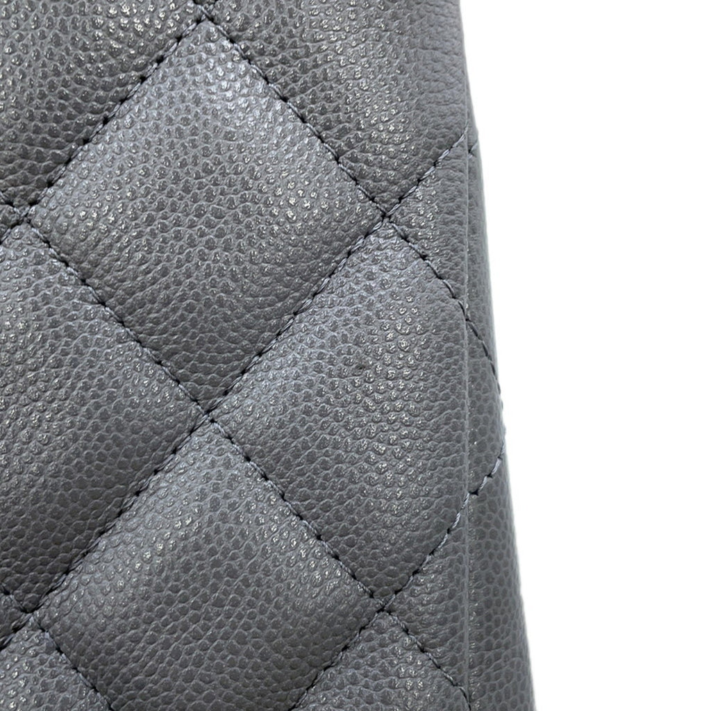 Detailed view of the luxury designer tote bag Chanel showcasing quilted leather texture and stylish design
