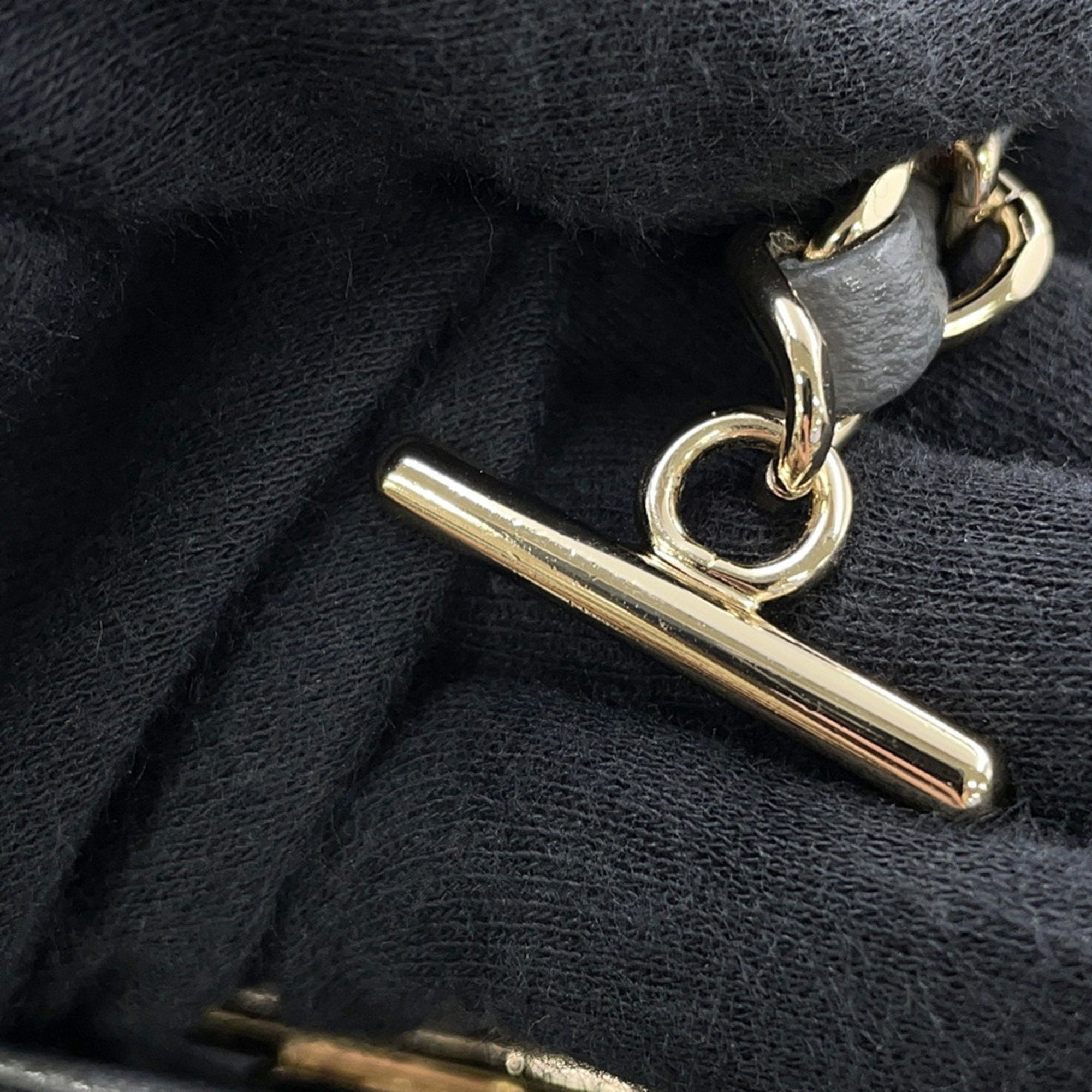 Close-up of gold hardware on luxury designer tote bag Chanel highlighting quality craftsmanship