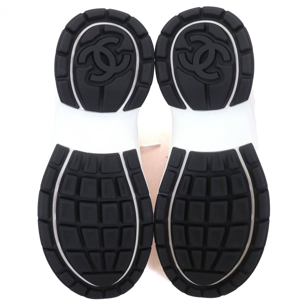 Underneath view of Chanel pink sneakers for women with textured black rubber soles