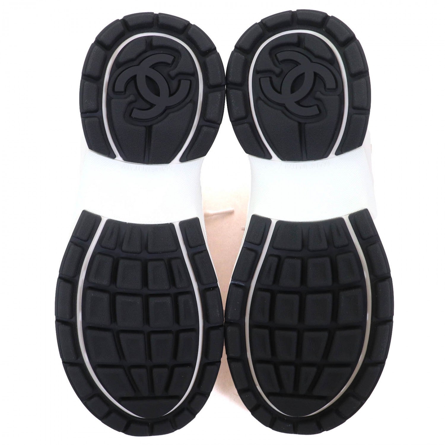 Underneath view of Chanel pink sneakers for women with textured black rubber soles