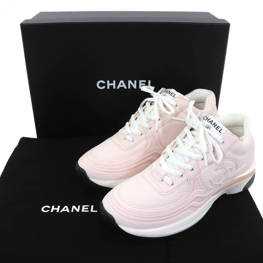 Chanel pink sneakers for women showcased with branded box and dust bag, perfect for casual styling