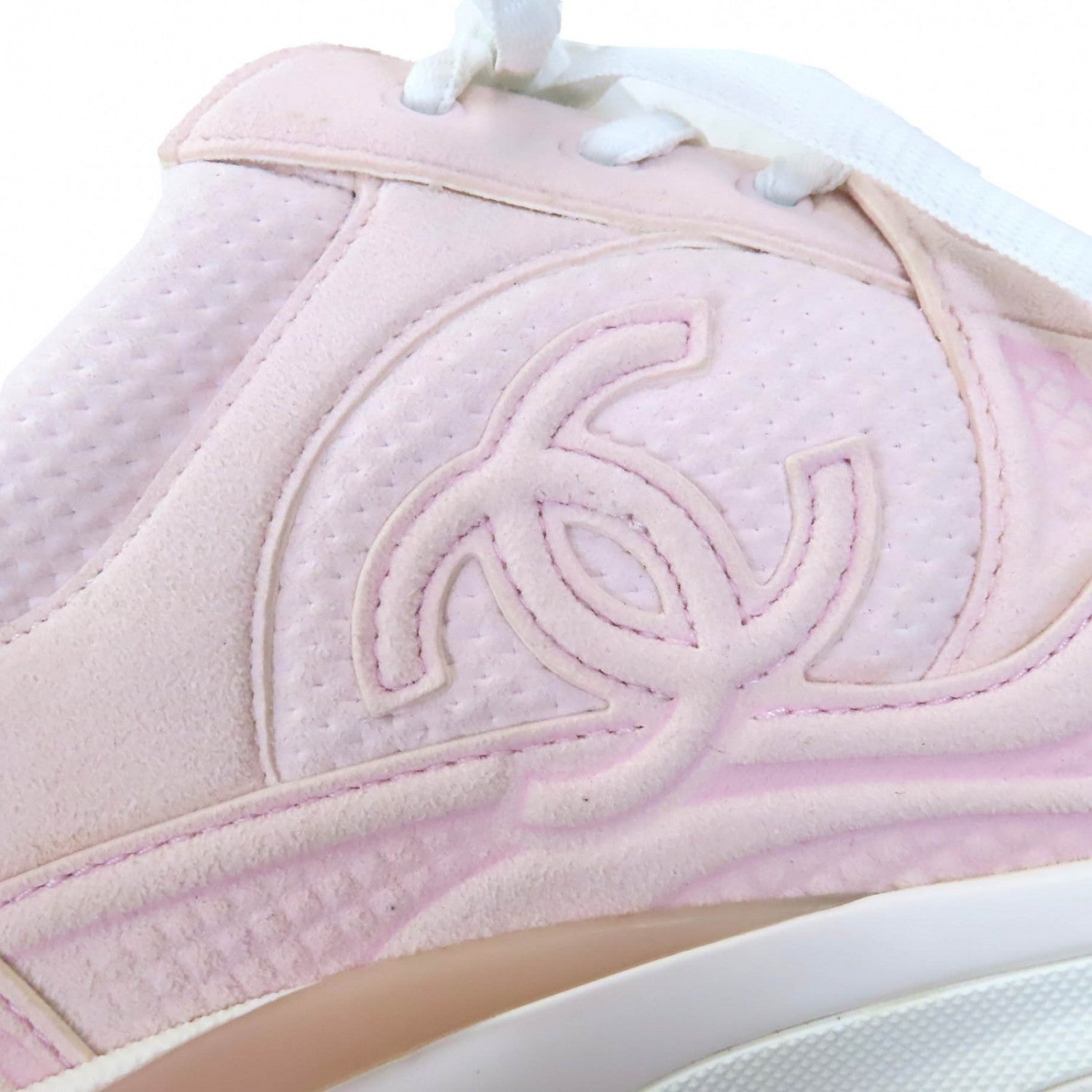 Chanel pink sneakers for women featuring a soft suede finish and iconic logo detailing