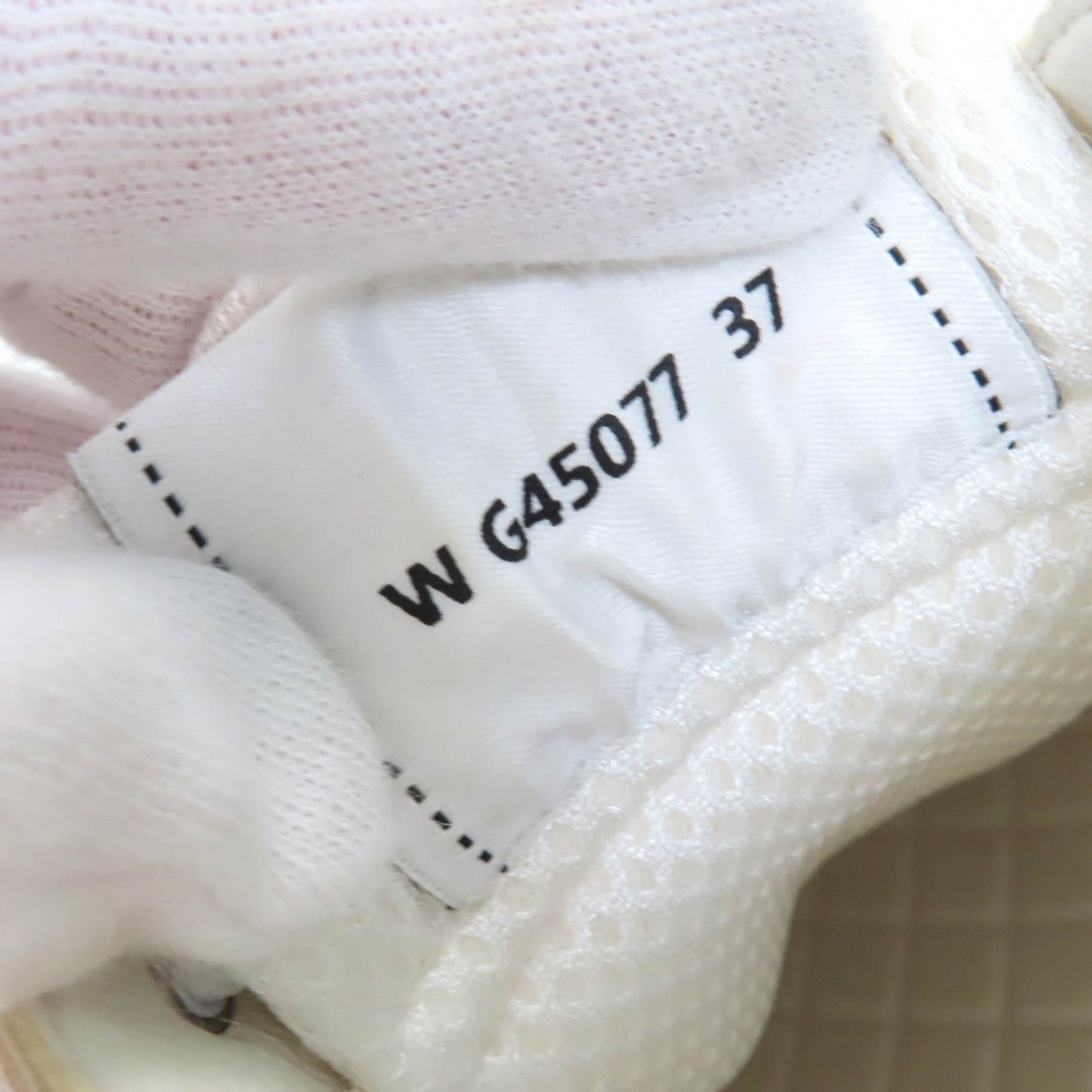 Close-up of Chanel pink sneakers for women showing the label and stitching details