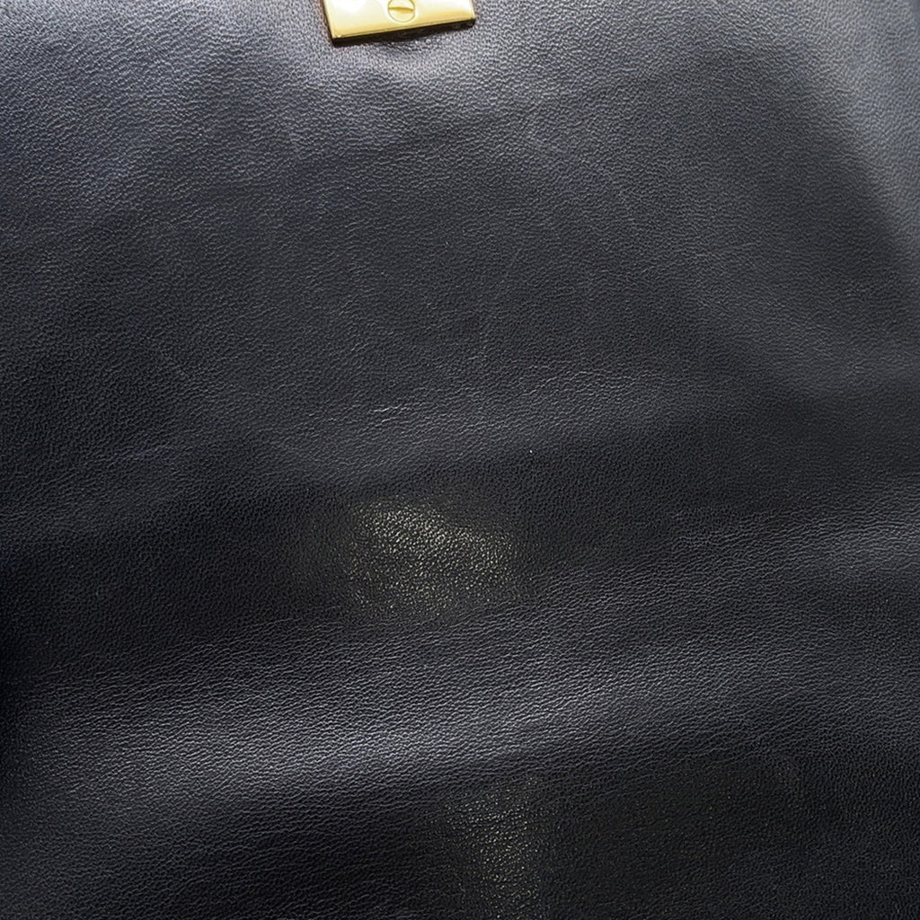 Close-up of MANSII CHANEL Pre-Loved Matelasse Full Flap handbag in classic black leather with gold hardware