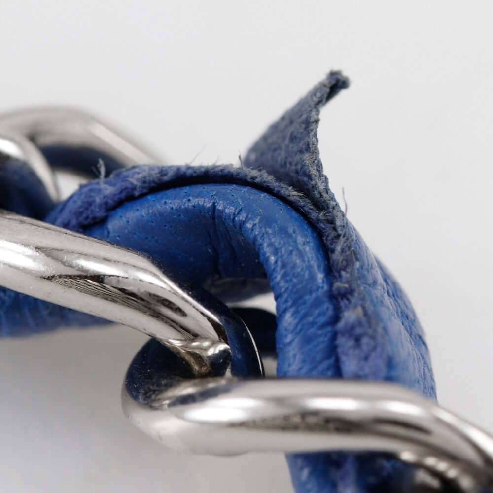 Close-up of CHANEL pre-owned bag strap featuring blue leather intertwined with a silver chain