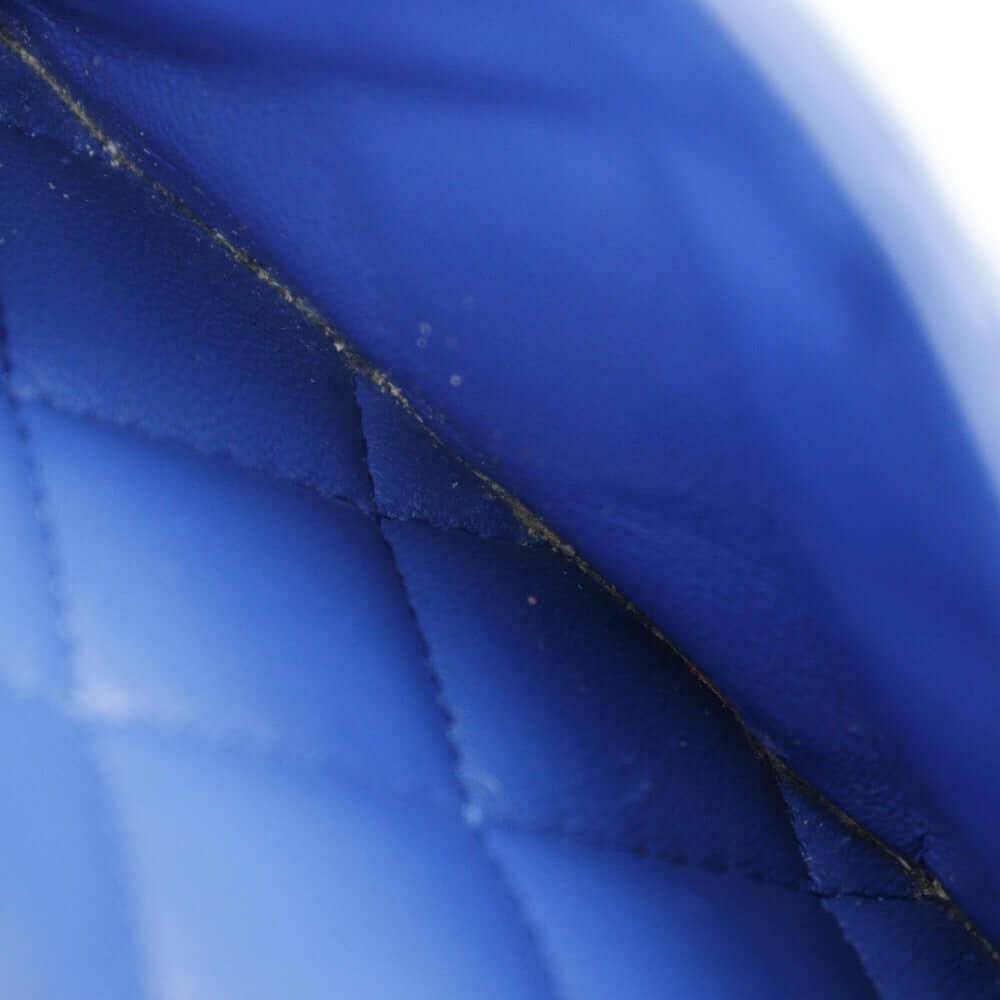 Close-up of a pre-owned CHANEL bag showcasing its quilted blue leather texture
