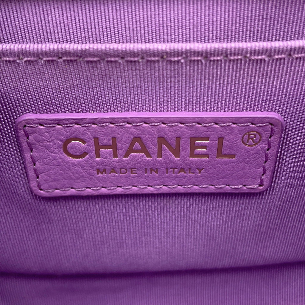 Chanel pre owned tag on a lavender bag made in Italy, showcasing luxury craftsmanship