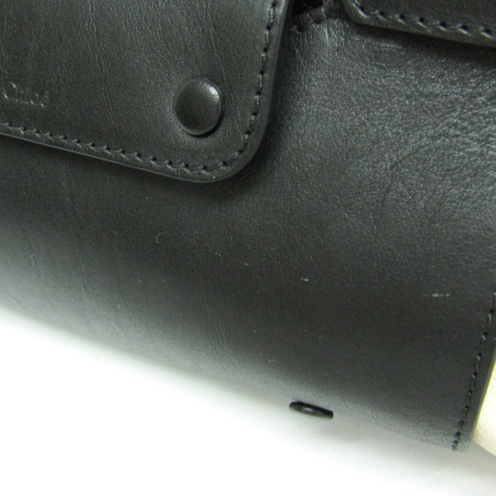 Close-up of CHLOÉ Pre-Loved Little Alice leather bag with button details and sleek finish