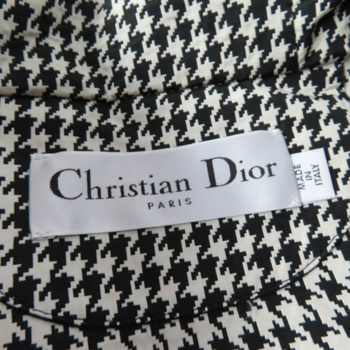 Inside label of a Christian Dior pre-loved anorak with houndstooth pattern detailing