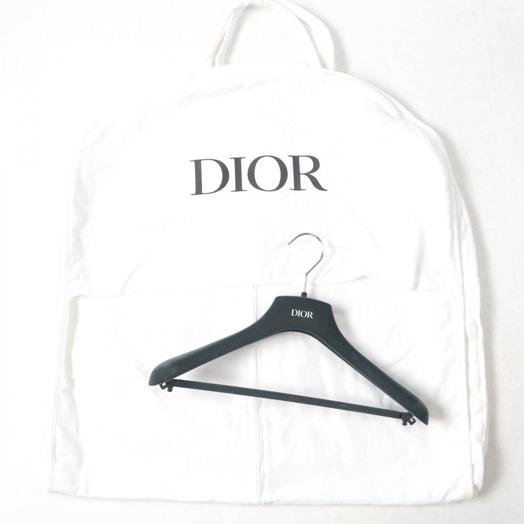 Christian Dior pre-loved anorak neatly stored in a protective garment bag with logo