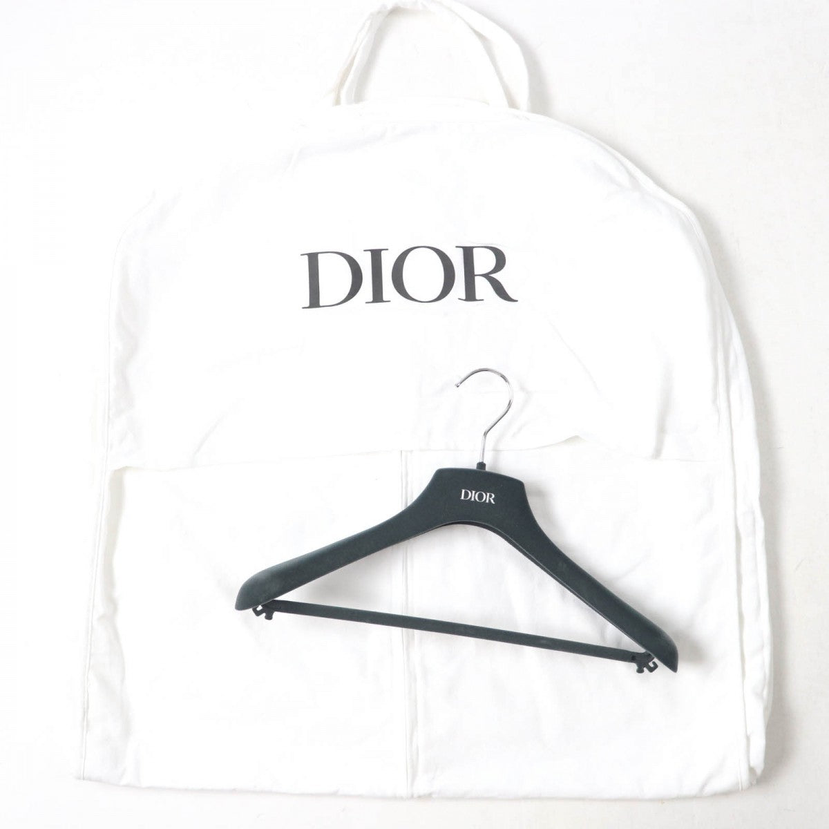 Christian Dior pre-loved anorak neatly stored in a protective garment bag with logo