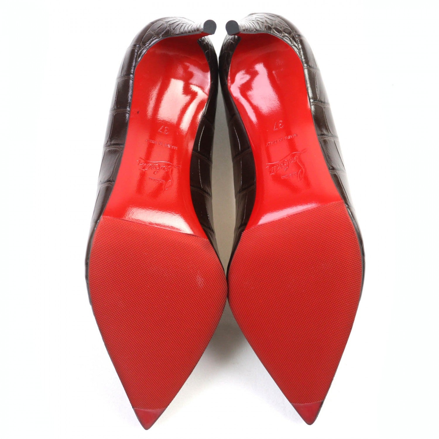 Sleek black pre-owned Christian Louboutin pumps with iconic red soles and pointed toes