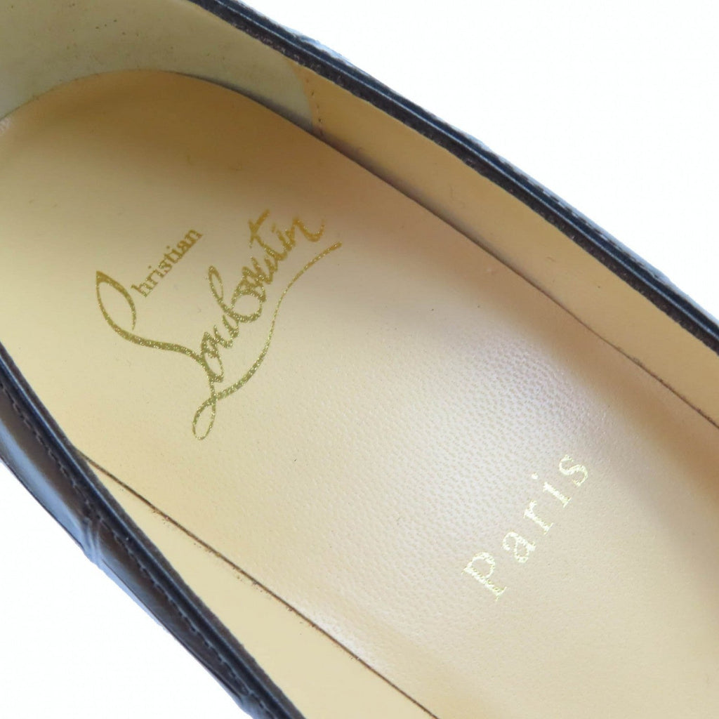 Close-up of pre-owned Christian Louboutin pumps showing the iconic logo inside the shoe