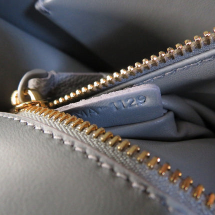Close-up of a Christian Dior bag in Like New condition featuring a gold zipper detail