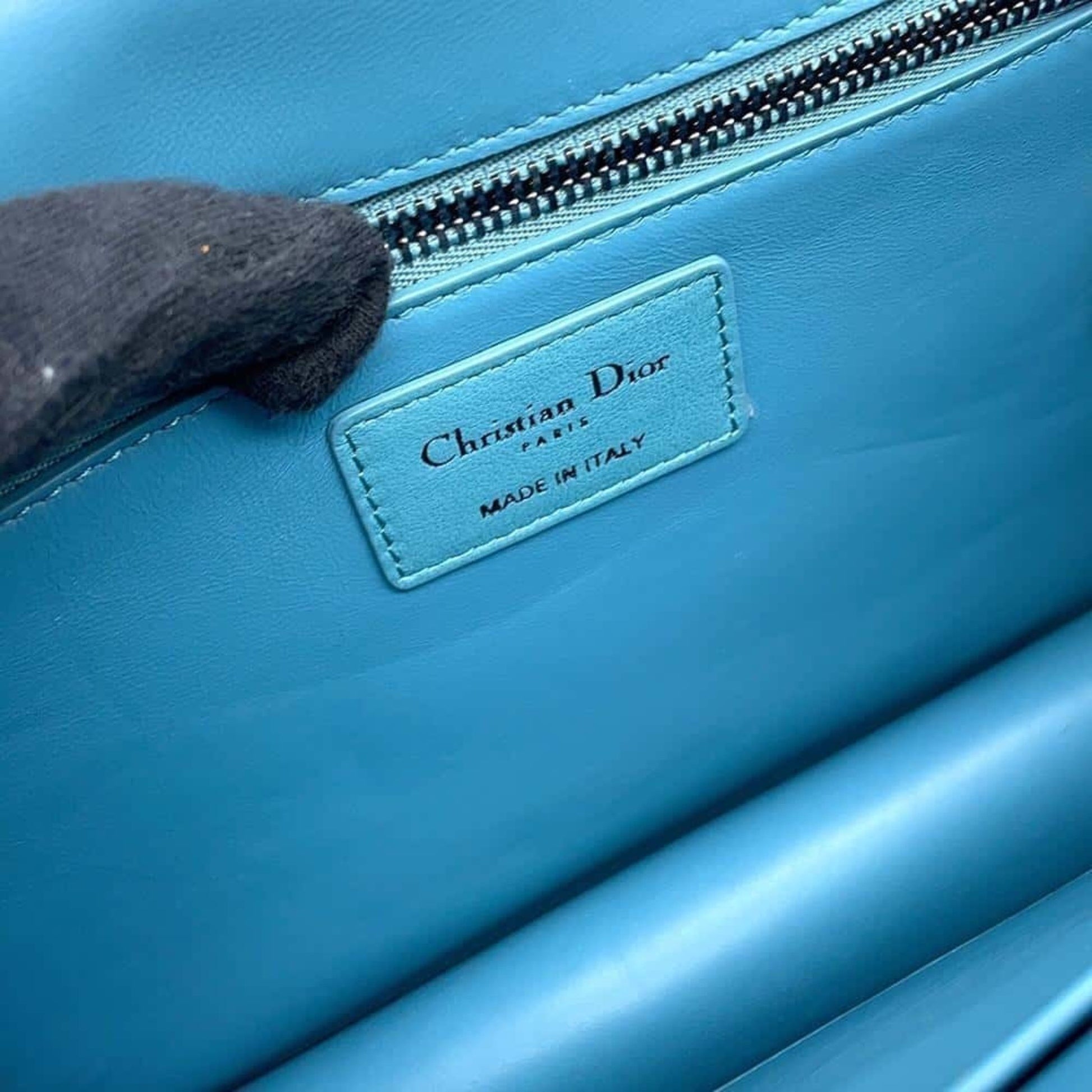 Pre-owned Christian Dior handbag interior featuring authentic Made in Italy label in vibrant blue
