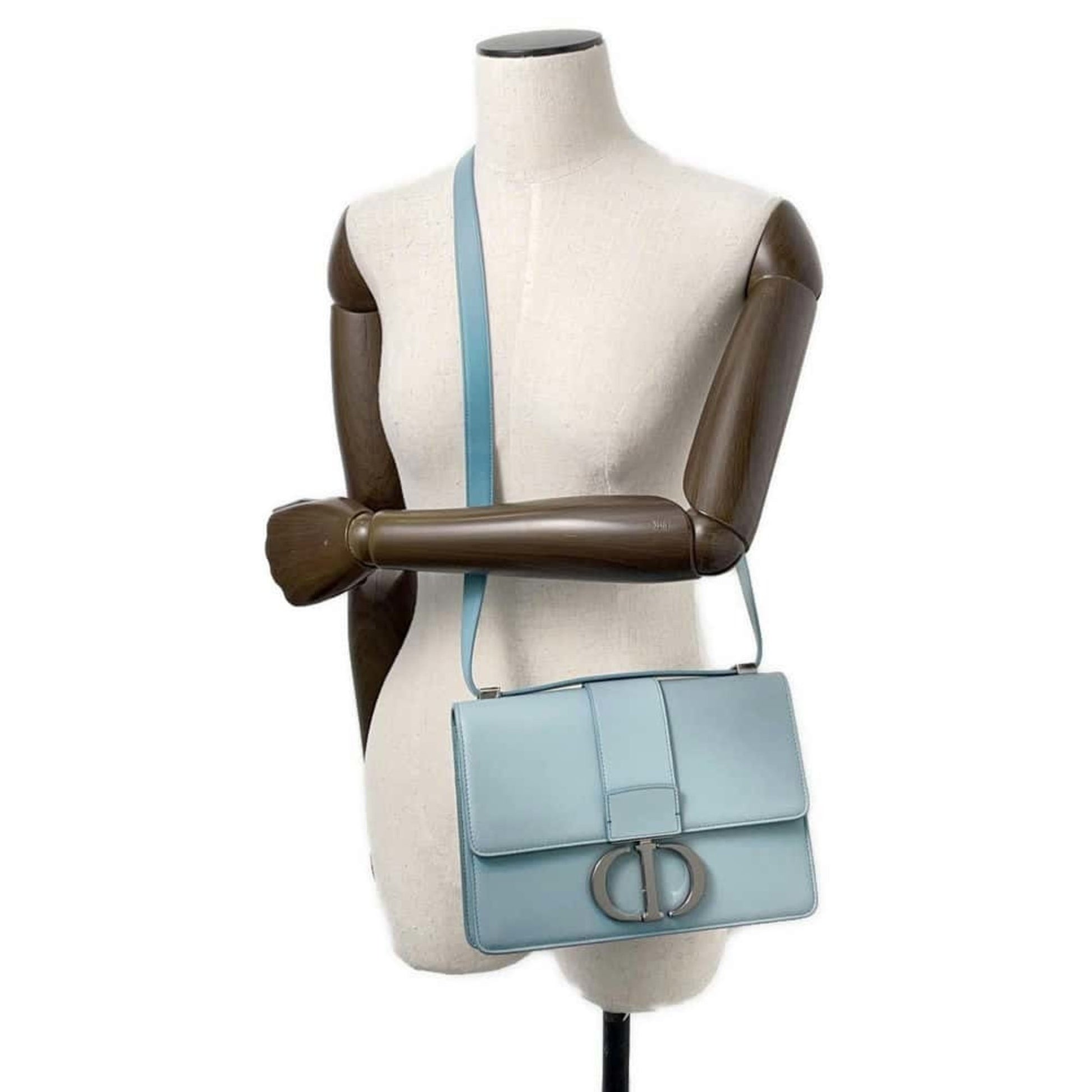 Pre-owned Christian Dior handbag in light blue with a stylish design and adjustable strap