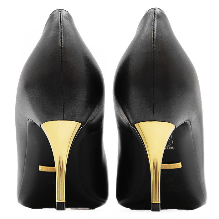 Elegant black used Gucci Nero pumps with striking gold heels to buy used Gucci Nero pumps online
