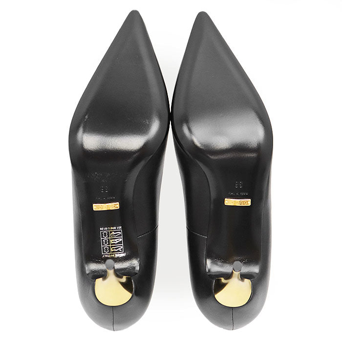 Top view of used Gucci Nero pumps with pointed toes and gold accents for stylish footwear options. Buy used Gucci Nero pumps online.