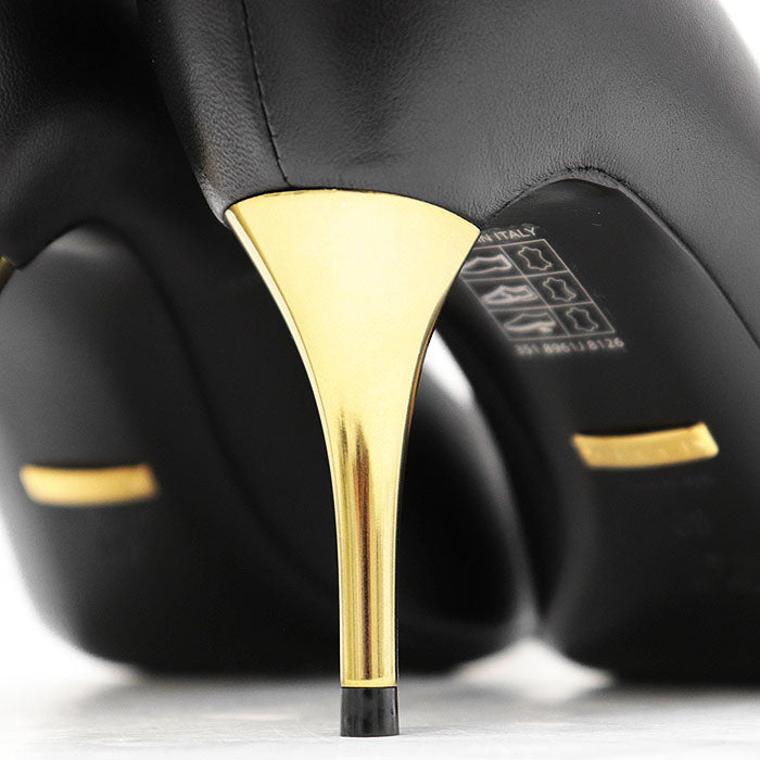 Close-up of GUCCI Nero pumps featuring a sleek design and gold heel, buy used Gucci Nero pumps online.