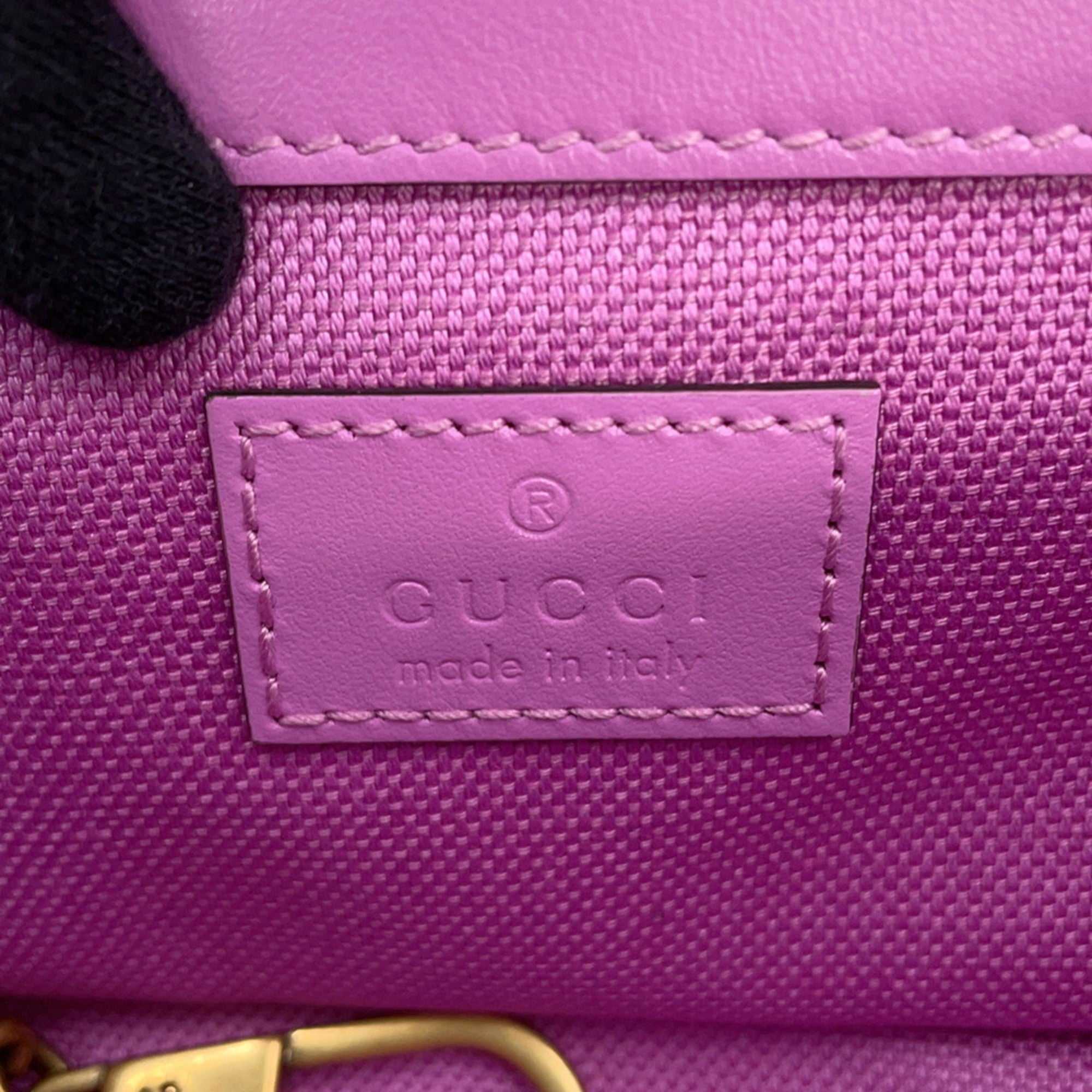 Close-up of GUCCI Pre-Loved GG Super Mini Canvas bag label showcasing quality craftsmanship and branding