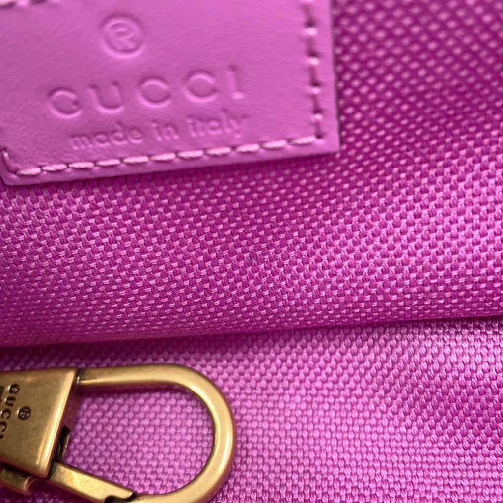 Close-up of GUCCI Pre-Loved GG Super Mini Canvas bag showcasing pink fabric and logo details